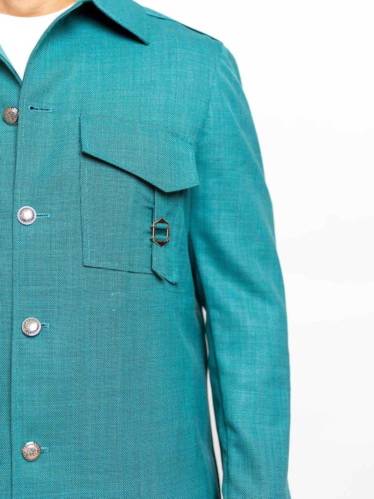 Teal jacket with buttons and a pocket on a white background