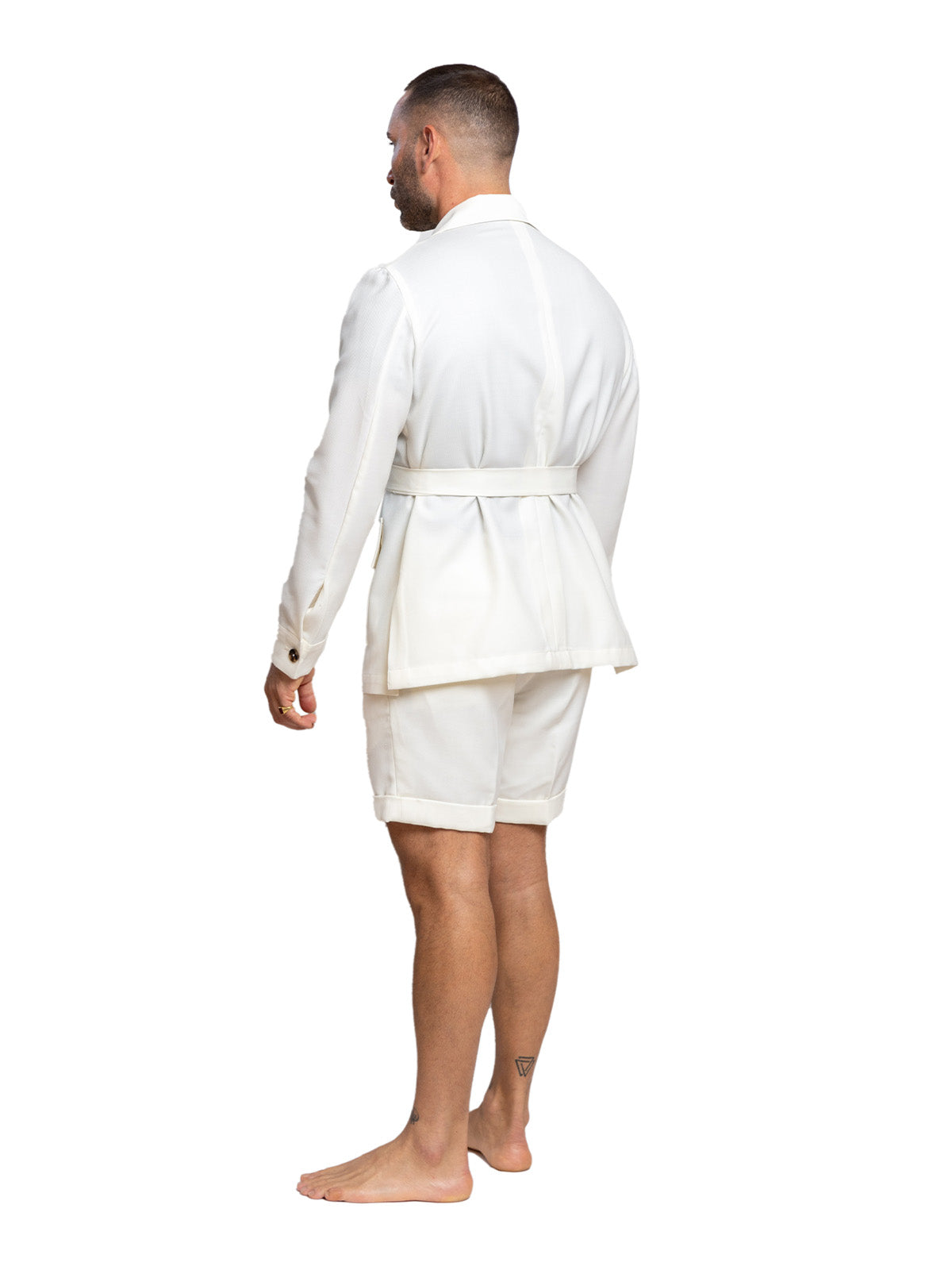 Man wearing a white suit with shorts on a white background